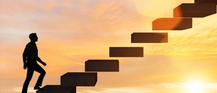Businessman in career promotion concept with stairs